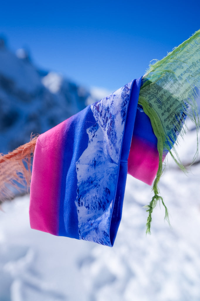 Arctic Moonrise headband hanging on flags with a snowy backdrop